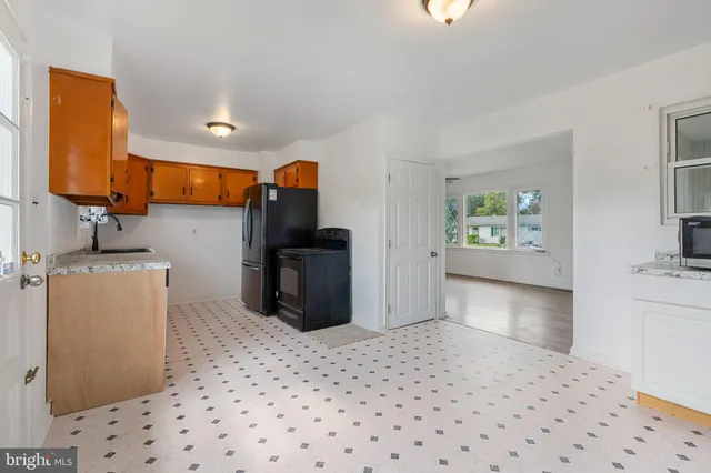 a kitchen with stainless steel appliances a refrigerator sink and stove