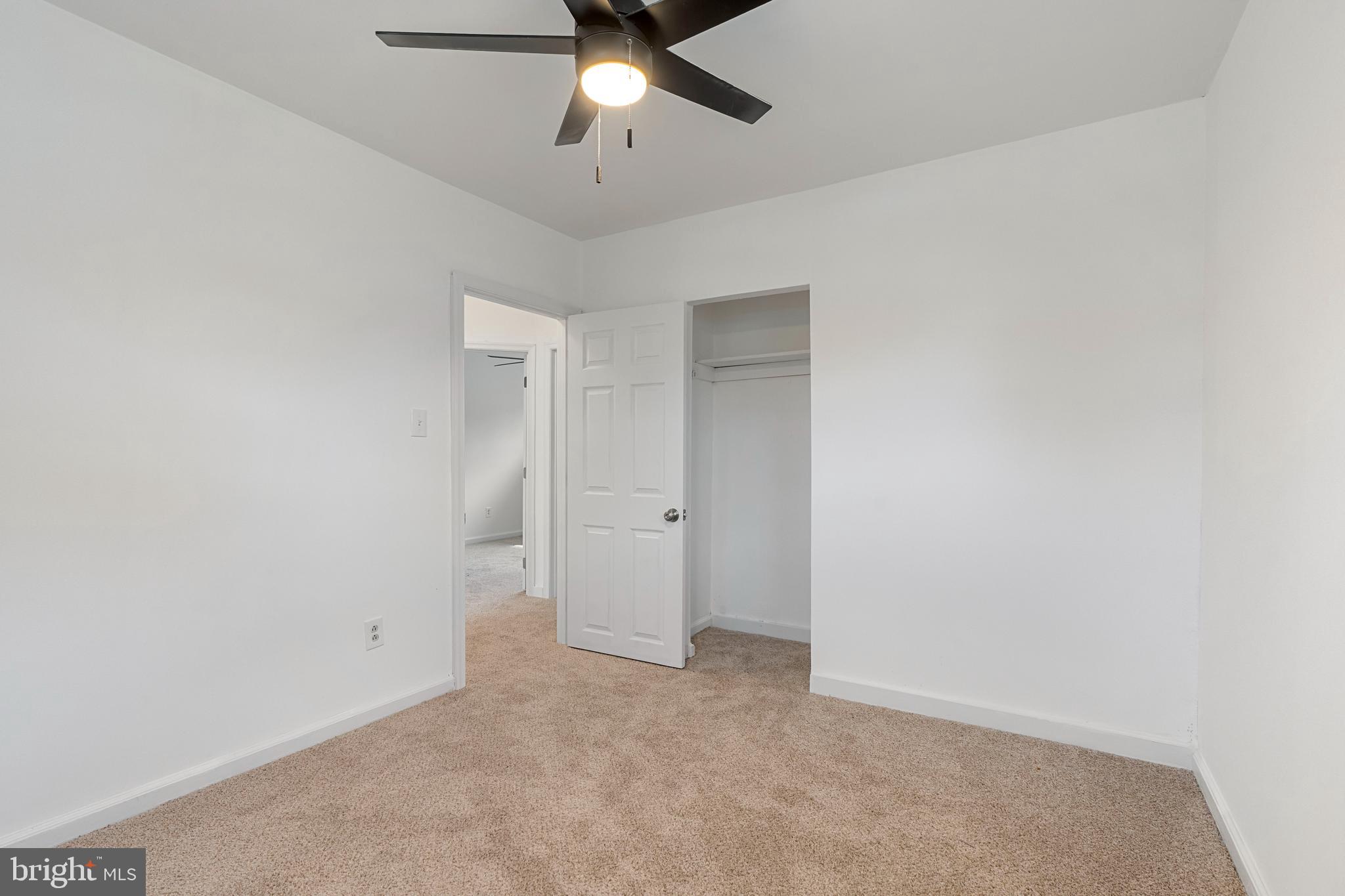 18 John Collins Circle Dover, DE 19904 - Photo 10 of 17 an empty room with a ceiling fan and carpet
