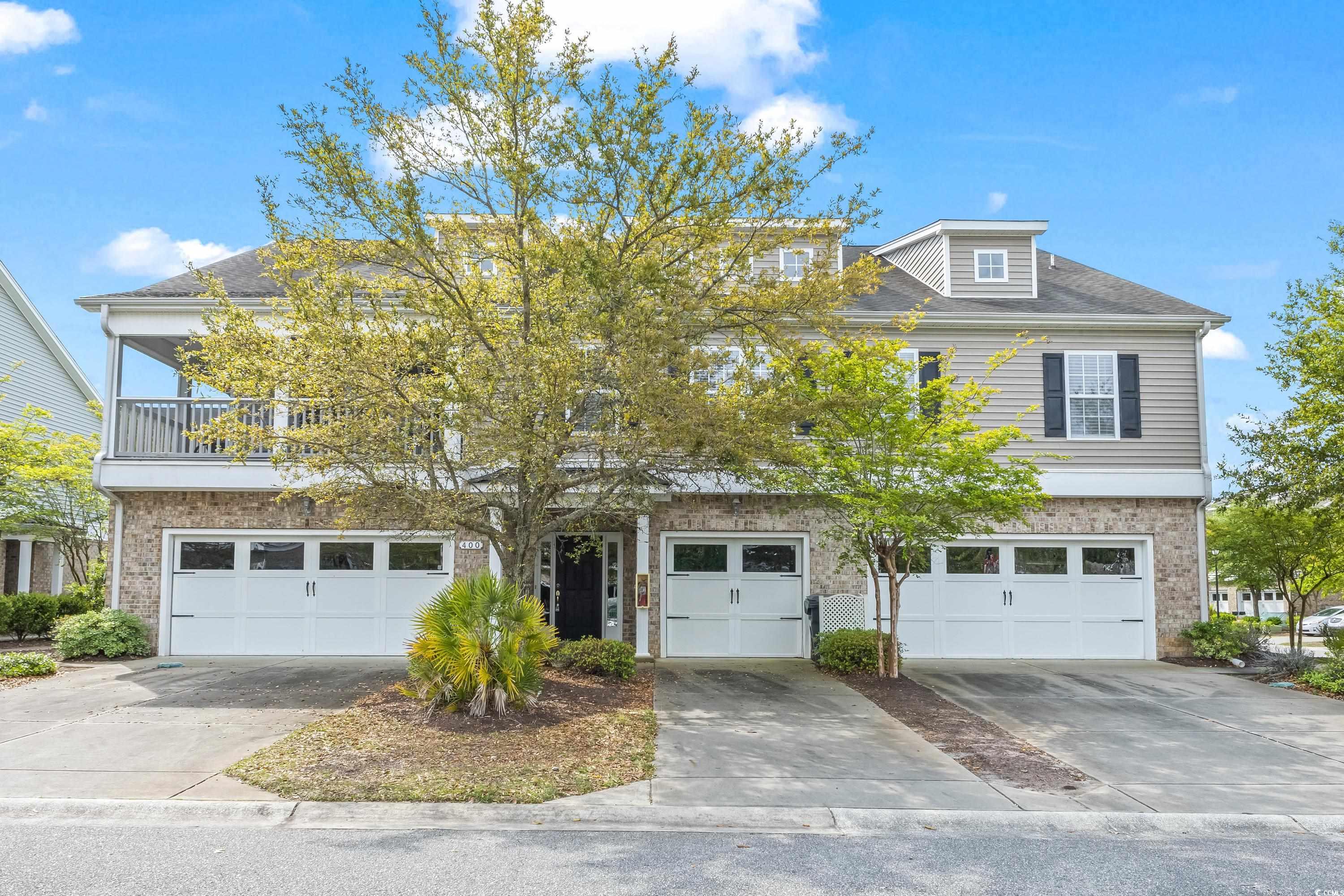 400 Black Smith Lane, Unit A Myrtle Beach, SC 29579 - Photo 1 of 35 View of front of property featuring brick siding, concrete driveway, an attached garage, and a balcony