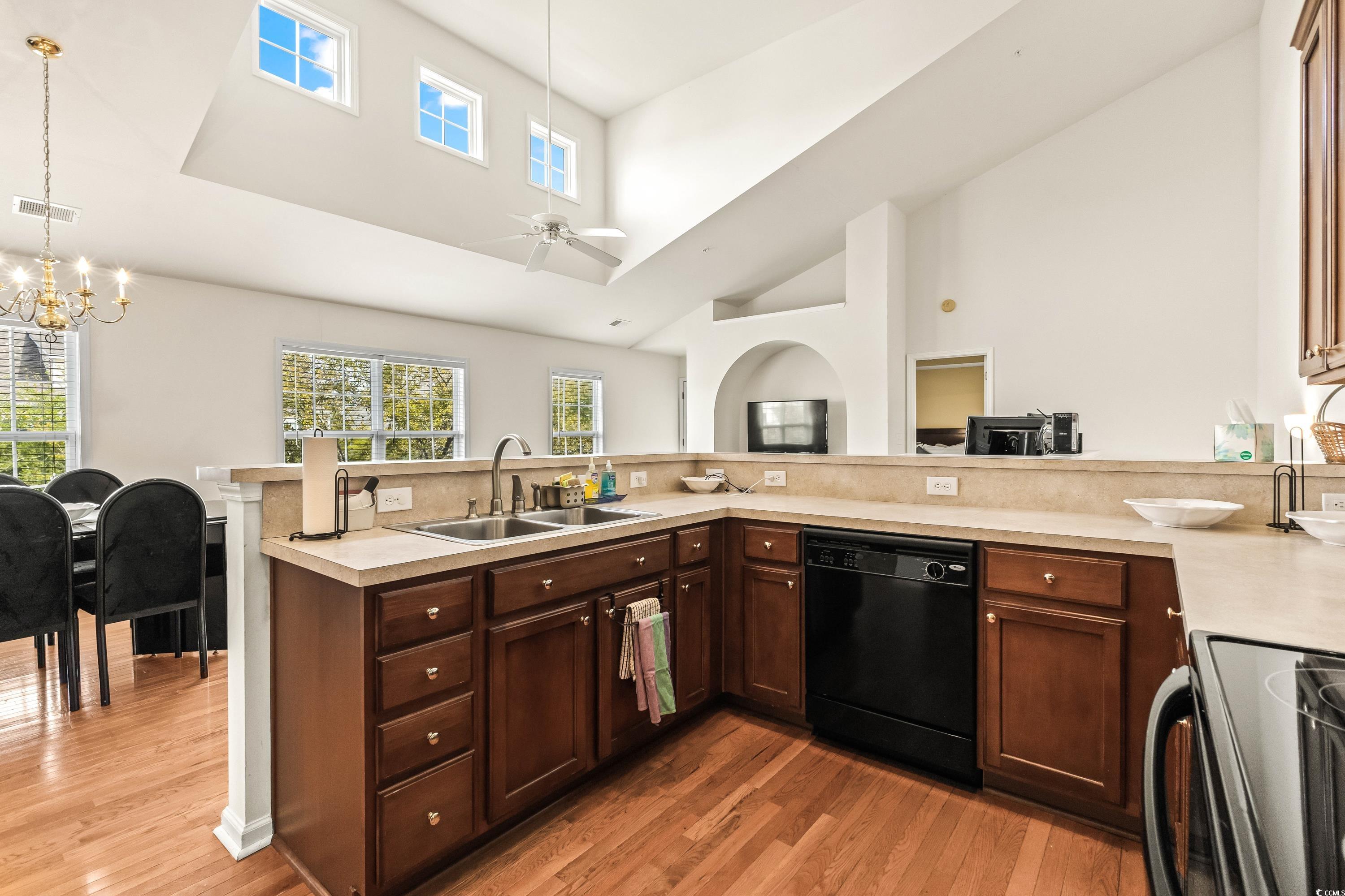 400 Black Smith Lane, Unit A Myrtle Beach, SC 29579 - Photo 13 of 35 Kitchen featuring high vaulted ceiling, electric stove, light countertops, black dishwasher, and dark brown cabinets