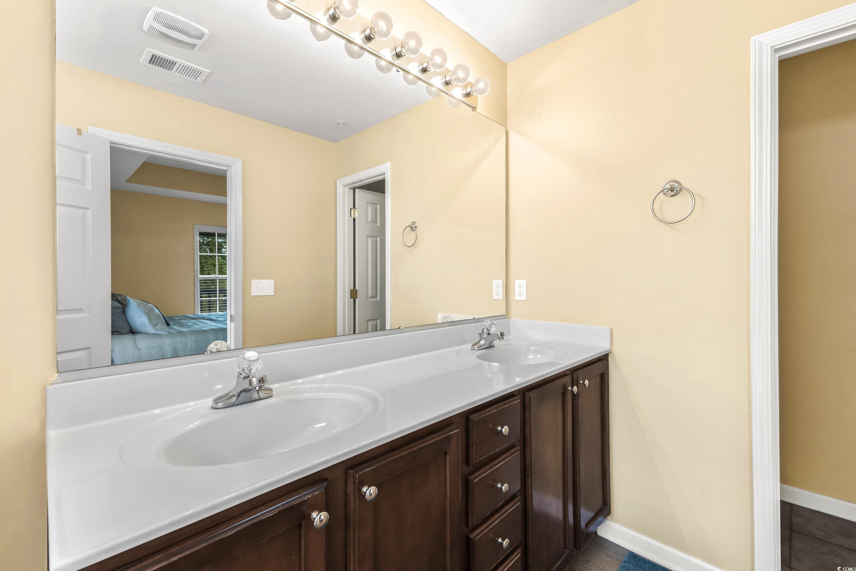 400 Black Smith Lane, Unit A Myrtle Beach, SC 29579 - Photo 24 of 35 Ensuite bathroom featuring double vanity and baseboards