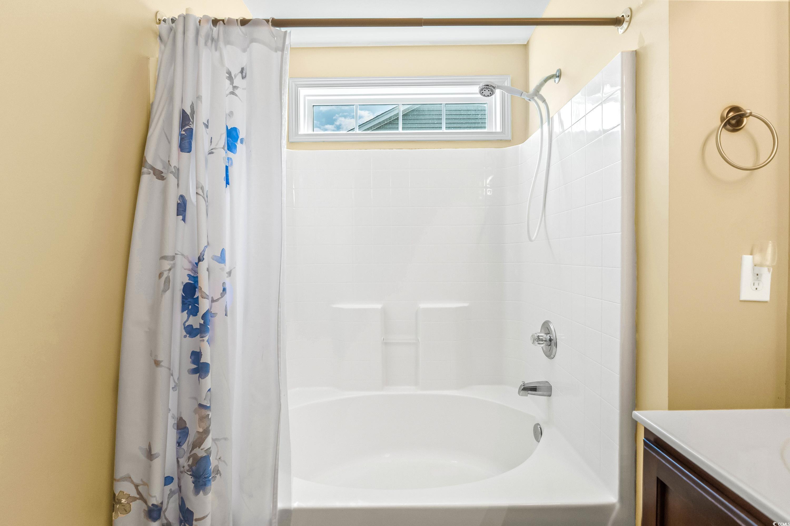 400 Black Smith Lane, Unit A Myrtle Beach, SC 29579 - Photo 25 of 35 Bathroom with shower / bathtub combination with curtain and vanity