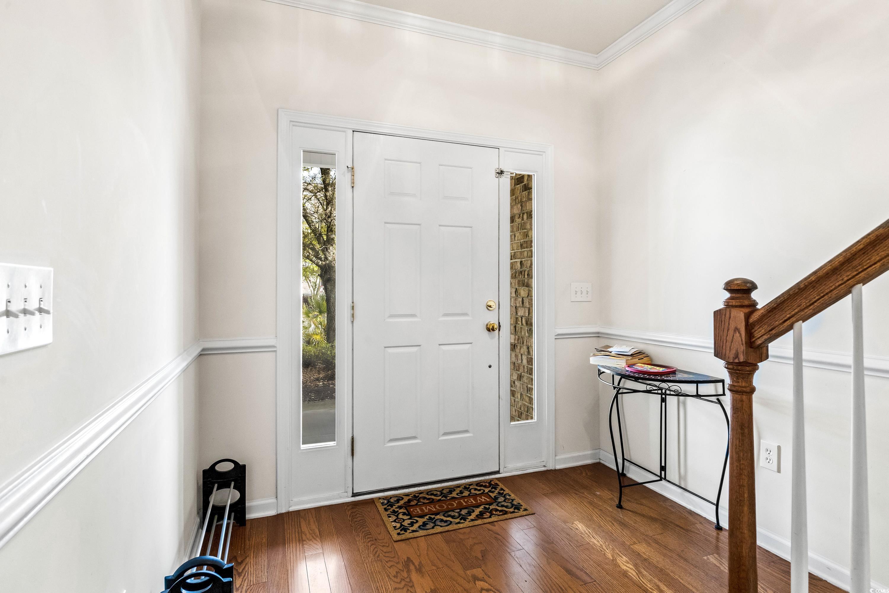 400 Black Smith Lane, Unit A Myrtle Beach, SC 29579 - Photo 4 of 35 Entryway with hardwood / wood-style floors, stairs, and crown molding