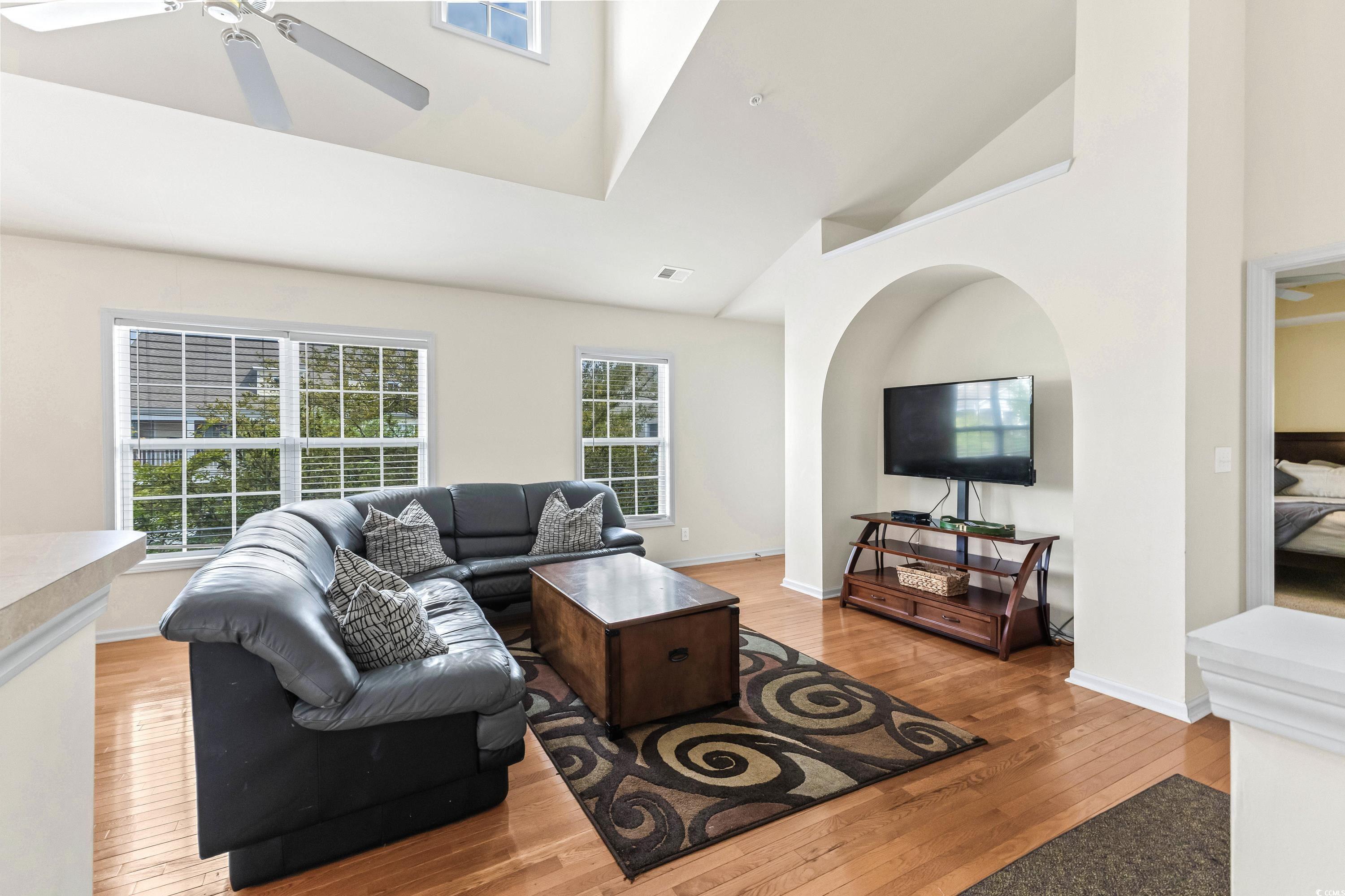 400 Black Smith Lane, Unit A Myrtle Beach, SC 29579 - Photo 6 of 35 Living room featuring light wood-type flooring, high vaulted ceiling, and a ceiling fan
