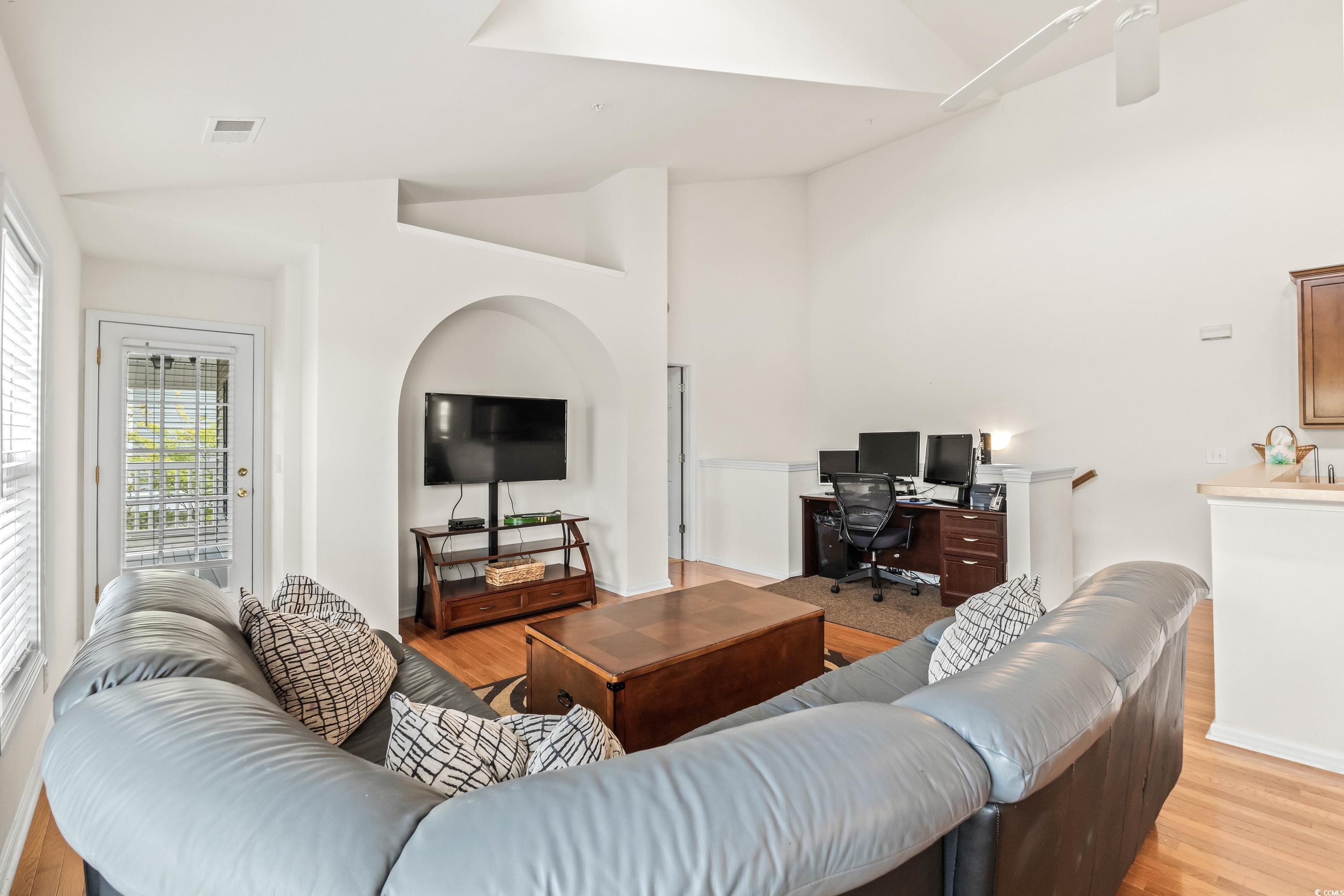 400 Black Smith Lane, Unit A Myrtle Beach, SC 29579 - Photo 7 of 35 Living area with an office area, light wood-type flooring, high vaulted ceiling, and a ceiling fan