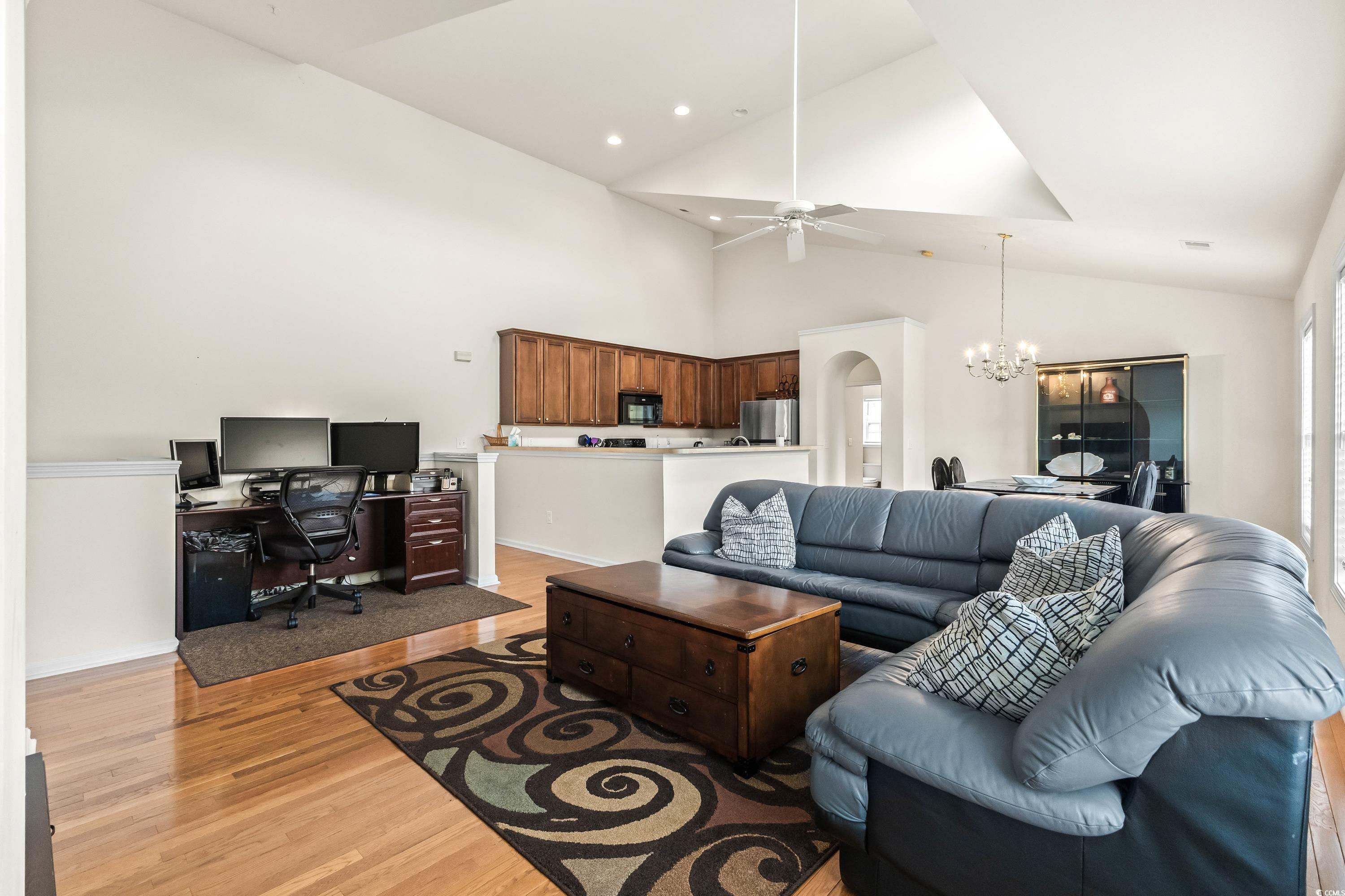 400 Black Smith Lane, Unit A Myrtle Beach, SC 29579 - Photo 8 of 35 Living room featuring a chandelier, a desk, ceiling fan, light wood-type flooring, and arched walkways
