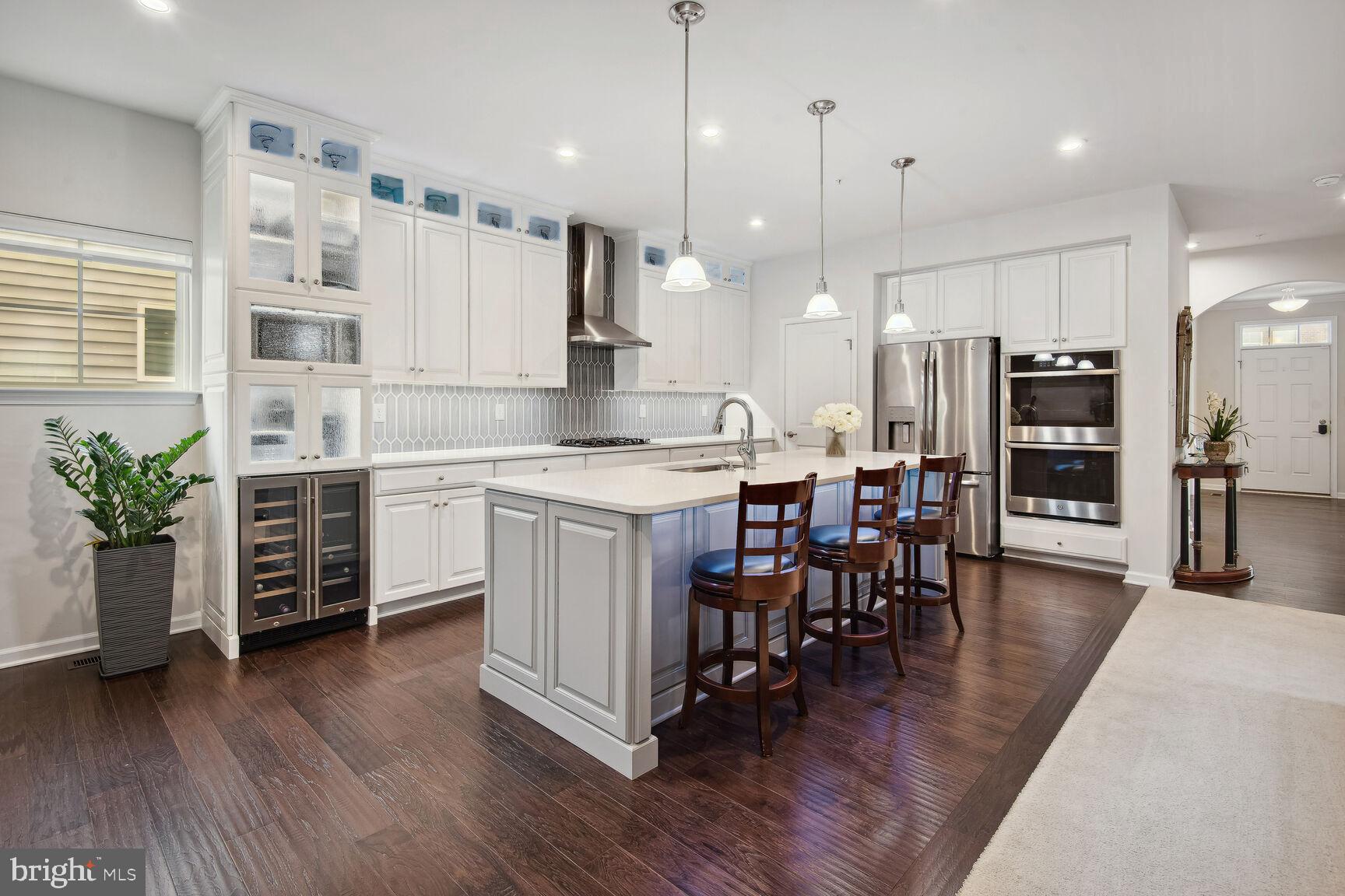 a kitchen with a table chairs refrigerator and microwave