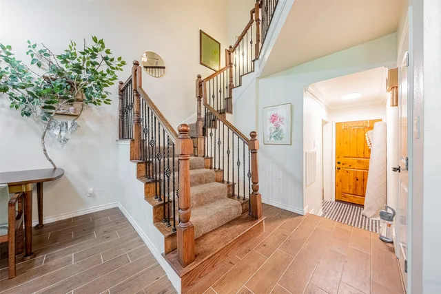 a view of entryway and hall with wooden floor