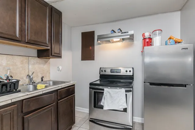 a kitchen with stainless steel appliances and cabinets