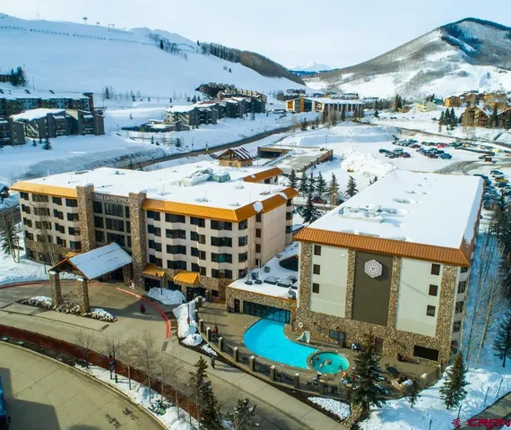 an aerial view of a house with a garden and lake view