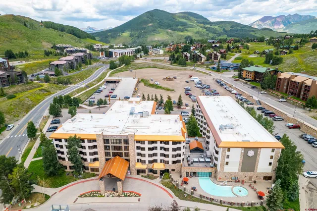 an aerial view of residential houses with outdoor space and street view