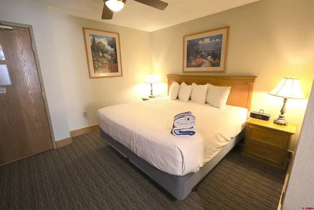 a view of a hallway with a livingroom and furniture