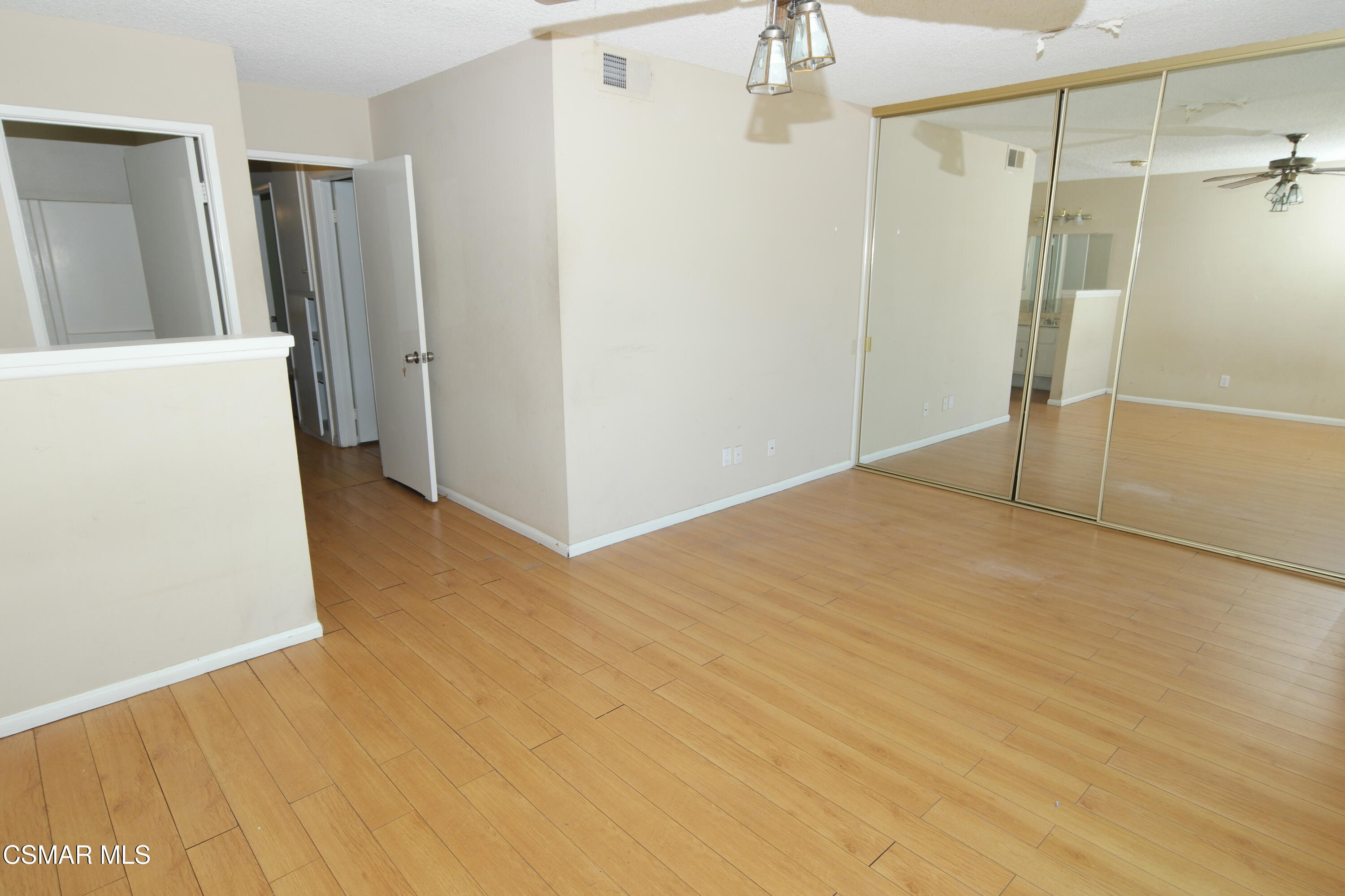18550 Dylan Street Porter Ranch, CA 91326 - Photo 19 of 27 a view of a big room with closet and wooden floor