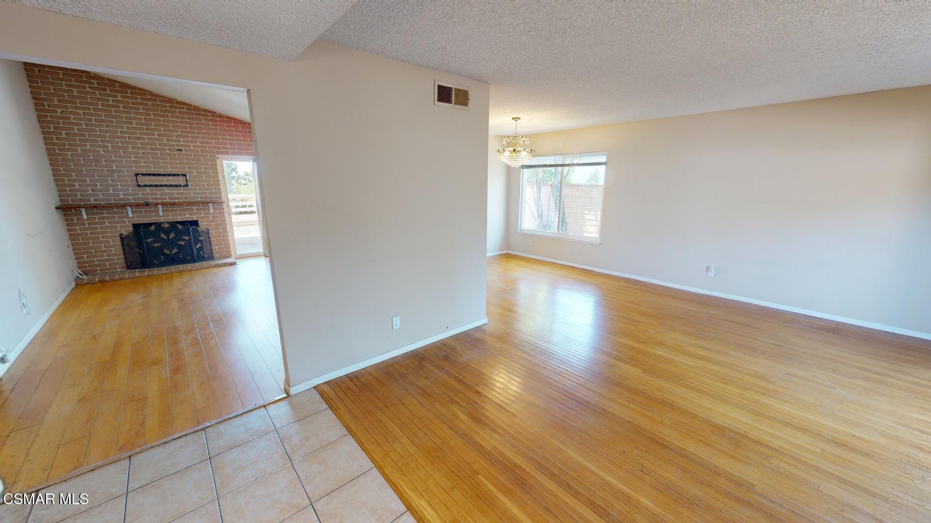 18550 Dylan Street Porter Ranch, CA 91326 - Photo 3 of 27 wooden floor in an empty room with a window