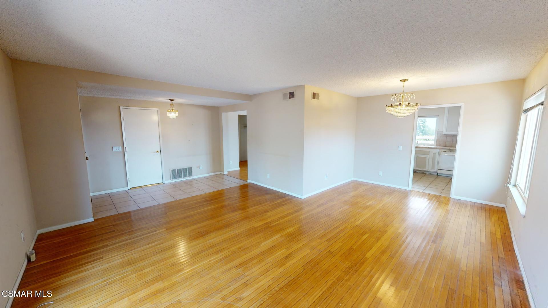 18550 Dylan Street Porter Ranch, CA 91326 - Photo 4 of 27 a view of empty room with wooden floor