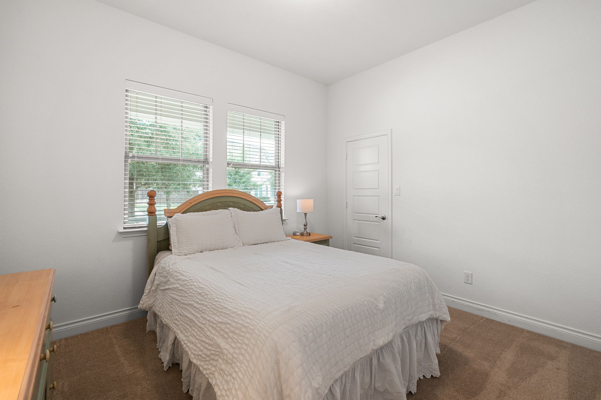 1908 Woolsey Way Leander, TX 78641 - Photo 19 of 36 Bedroom #4 features two sunlit windows and brand-new carpeting.