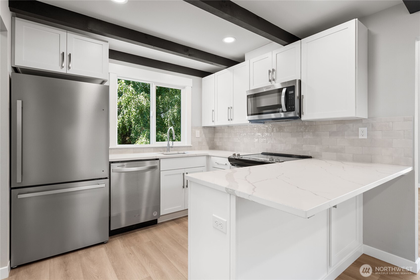 10005 North Davies Road Lake Stevens, WA 98258 - Photo 11 of 40 a kitchen with stainless steel appliances a refrigerator sink and microwave