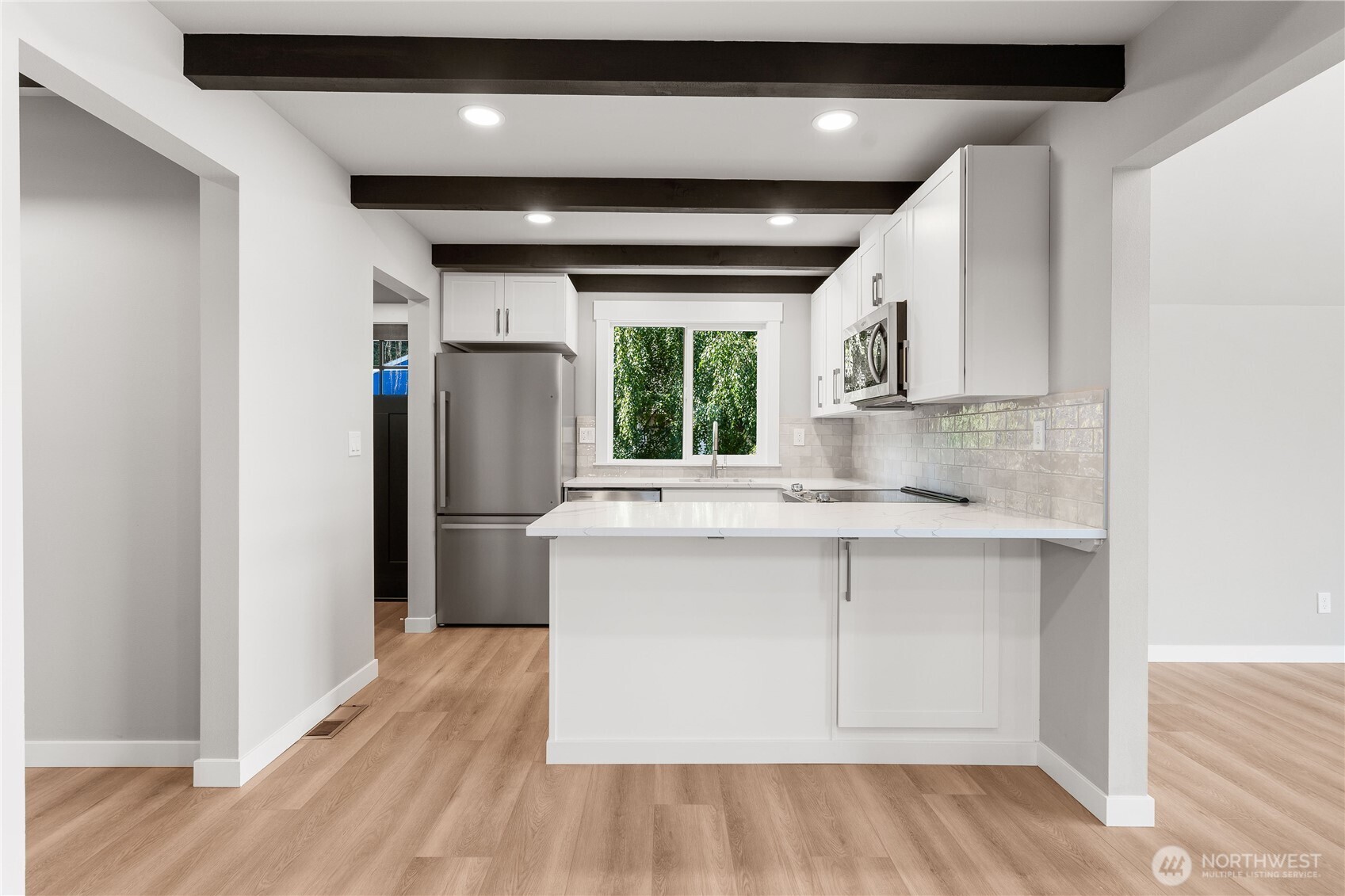 10005 North Davies Road Lake Stevens, WA 98258 - Photo 10 of 40 a kitchen with kitchen island a sink cabinets and wooden floor