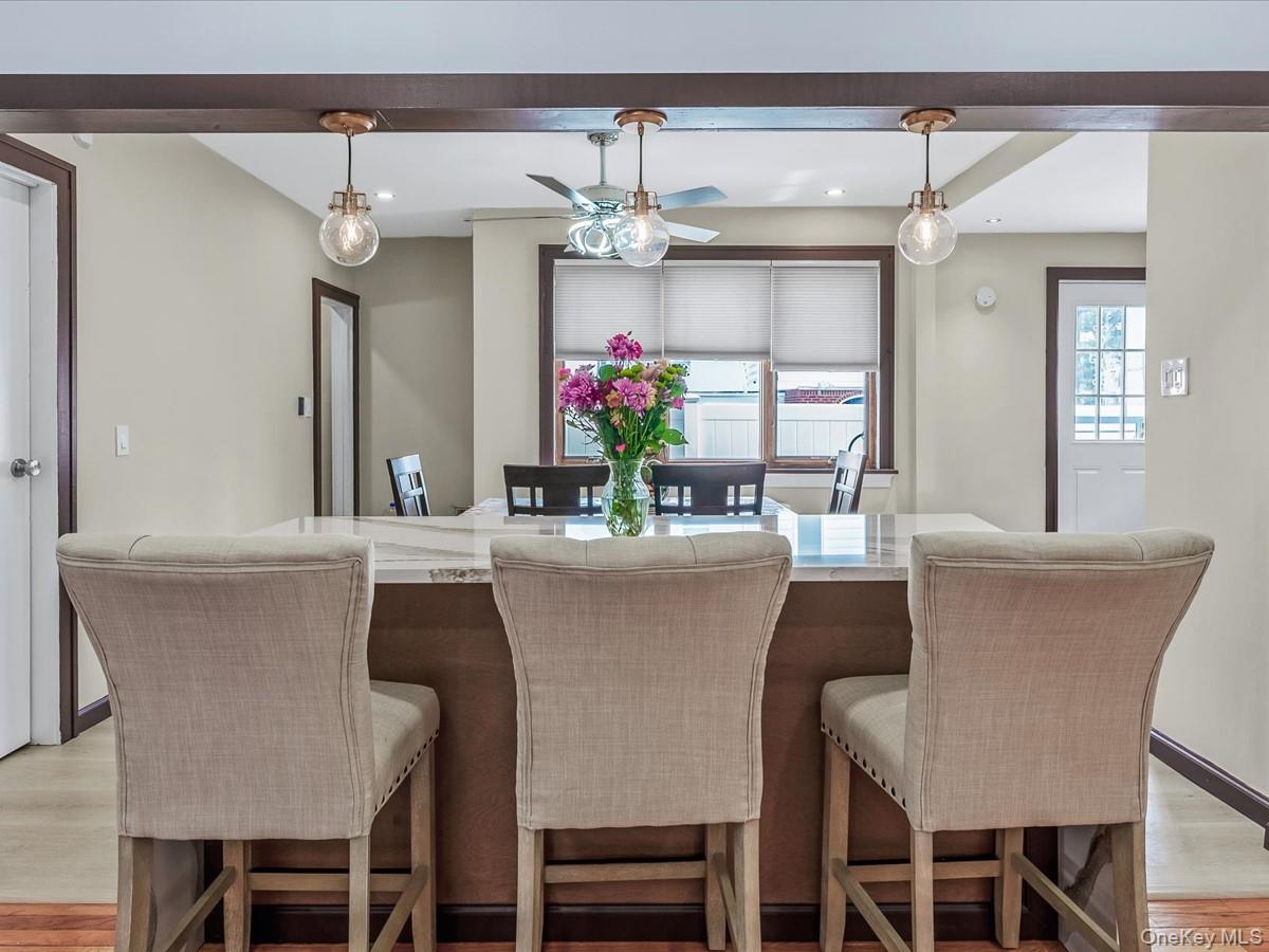 a dining table with chairs and view of kitchen