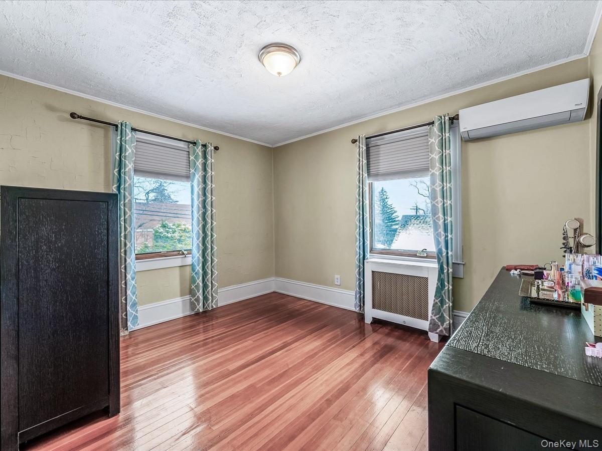 219-08 38th Avenue Queens, NY 11361 - Photo 13 of 24 a view of room with window and wooden floor