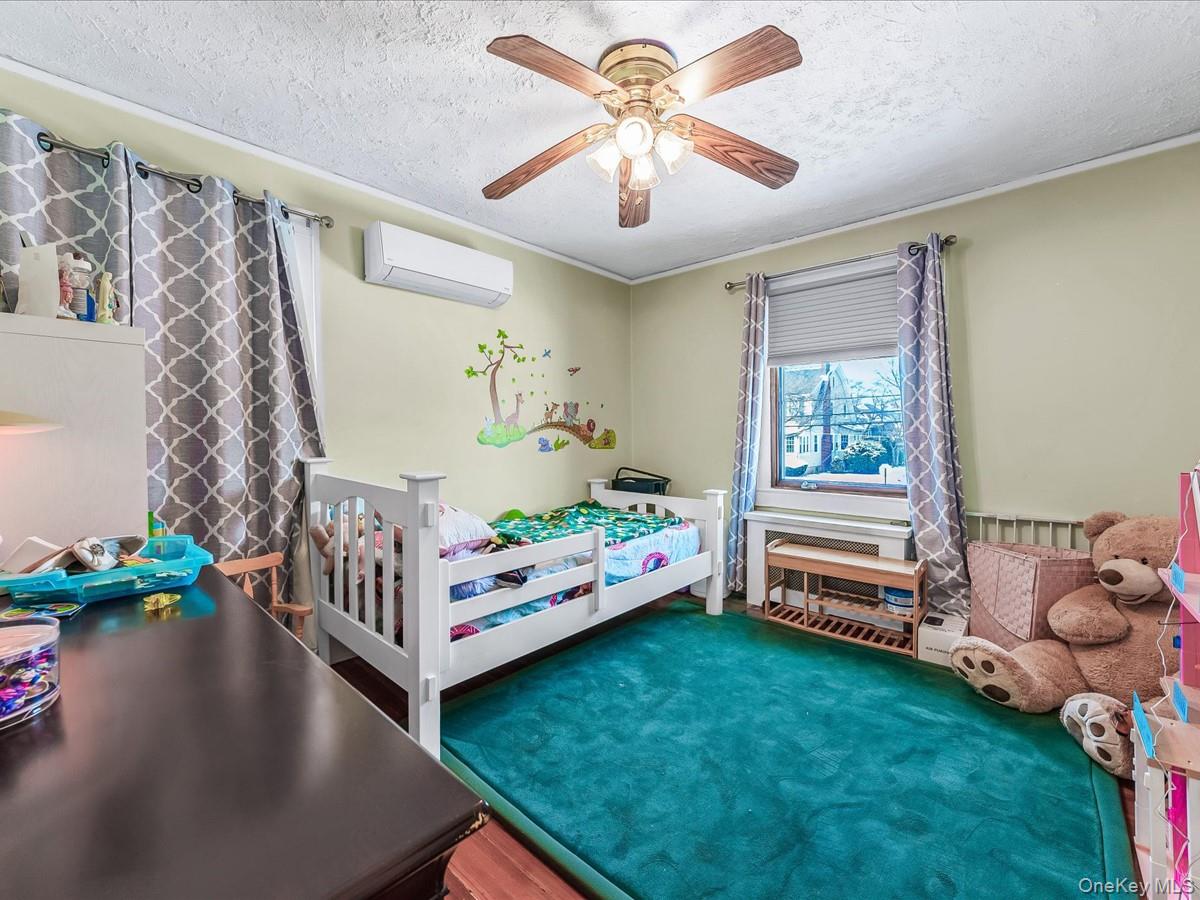 219-08 38th Avenue Queens, NY 11361 - Photo 14 of 24 a bedroom with furniture and a large window