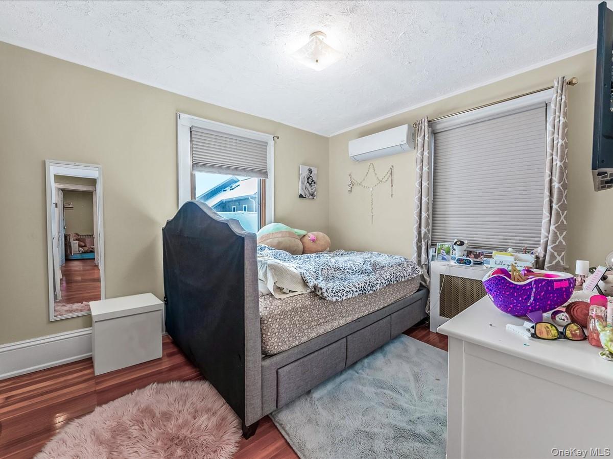 219-08 38th Avenue Queens, NY 11361 - Photo 15 of 24 a bedroom with bed and window