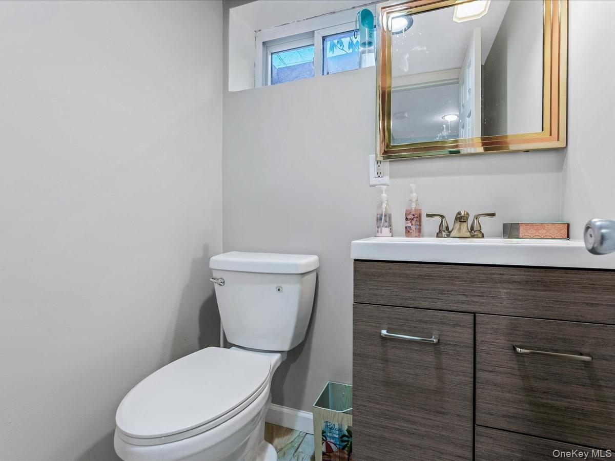 219-08 38th Avenue Queens, NY 11361 - Photo 19 of 24 a bathroom with a toilet sink and mirror