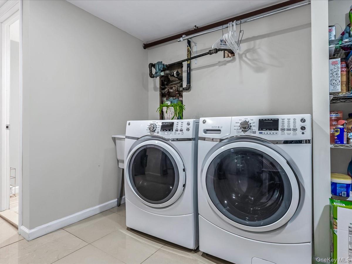219-08 38th Avenue Queens, NY 11361 - Photo 20 of 24 a utility room with dryer and washer
