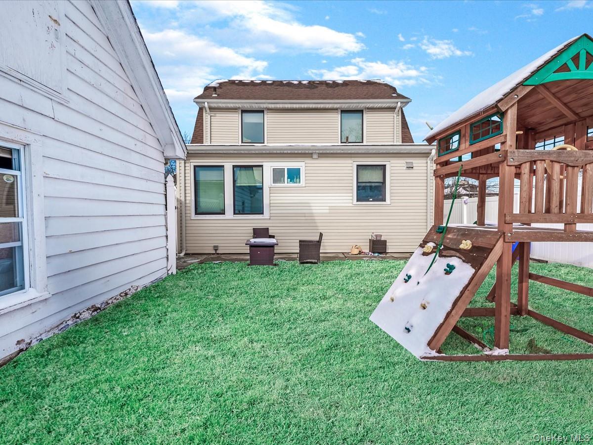 219-08 38th Avenue Queens, NY 11361 - Photo 23 of 24 a front view of a house with garden