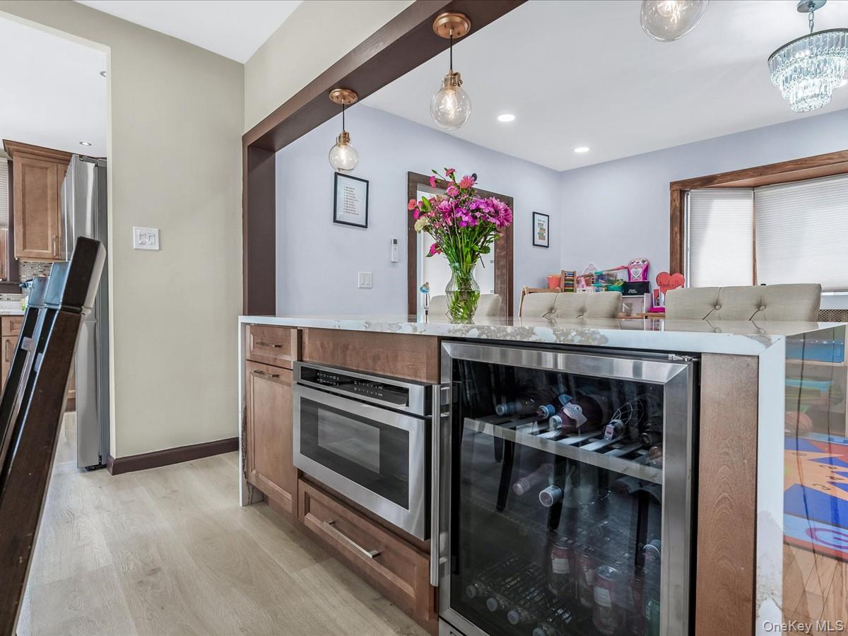 219-08 38th Avenue Queens, NY 11361 - Photo 3 of 24 a kitchen with stainless steel appliances granite countertop a stove and cabinets