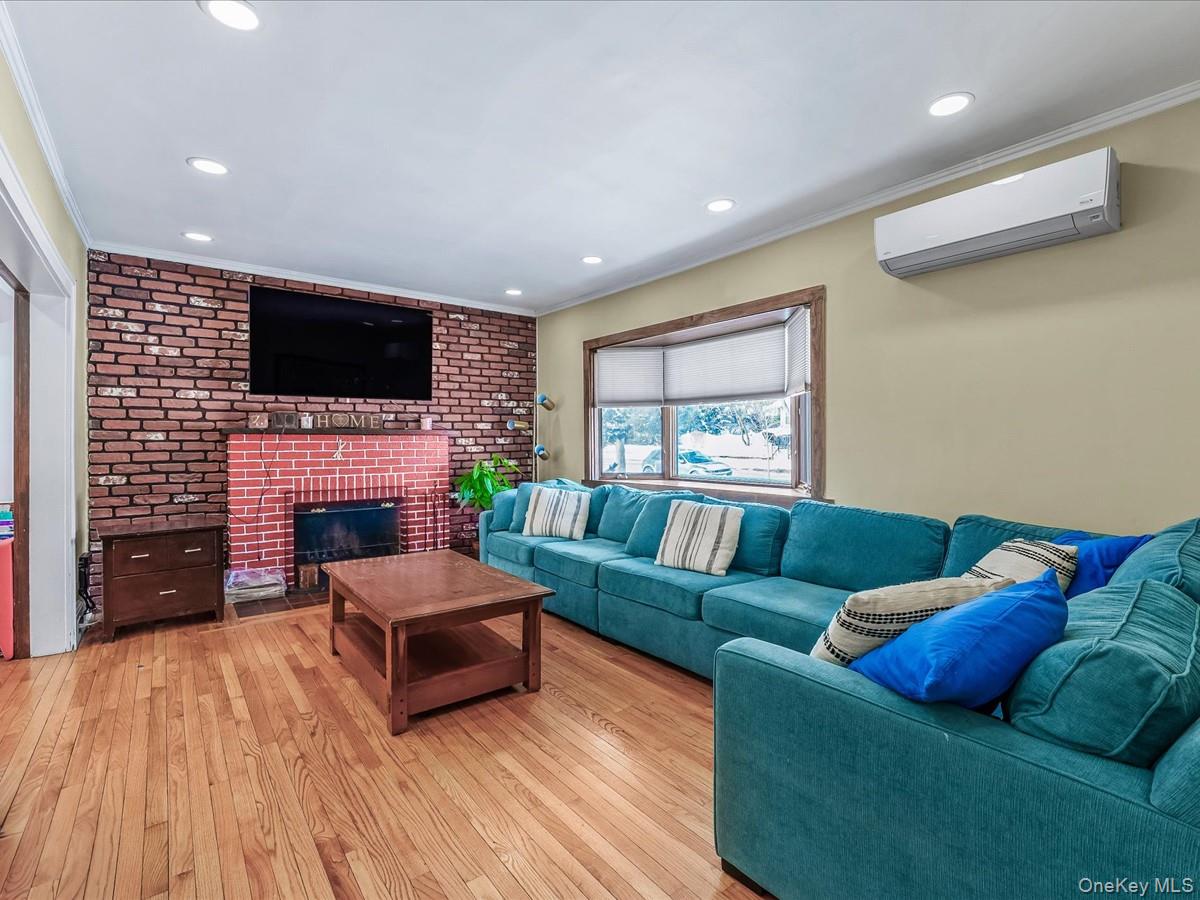 219-08 38th Avenue Queens, NY 11361 - Photo 5 of 24 a living room with furniture fireplace and flat screen tv