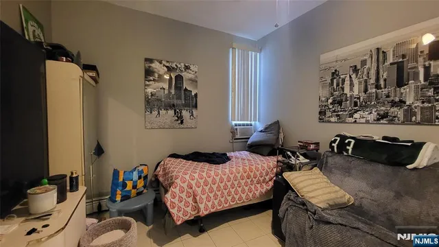 a bedroom with bed and a couch