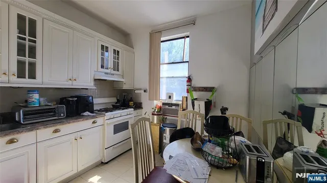 a view of a kitchen with workspace and wooden floor