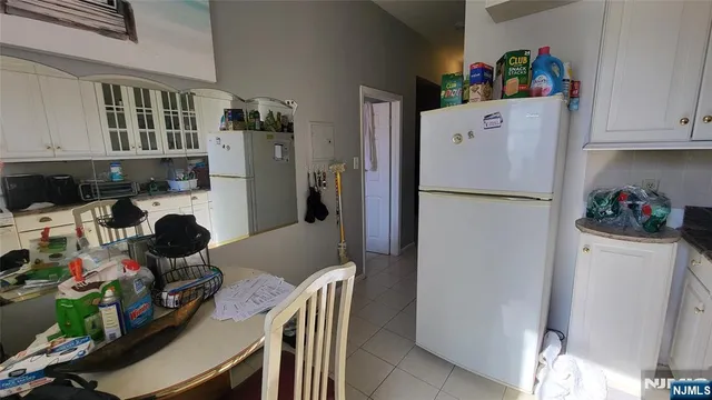 a white refrigerator freezer sitting inside of a kitchen