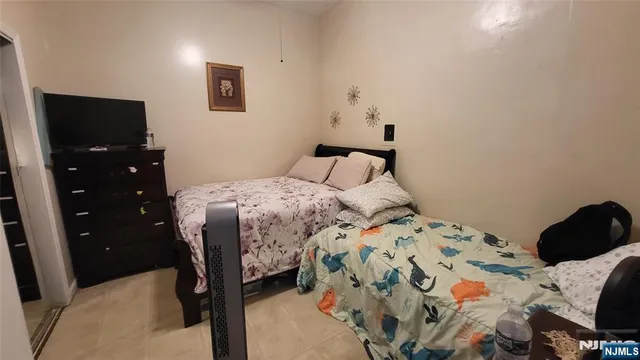 a bedroom with a bed and a television