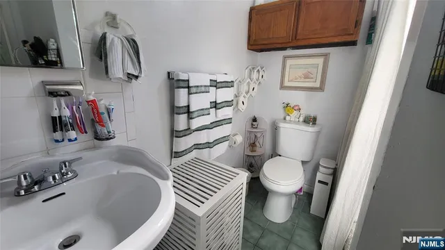 a bathroom with a sink toilet and mirror