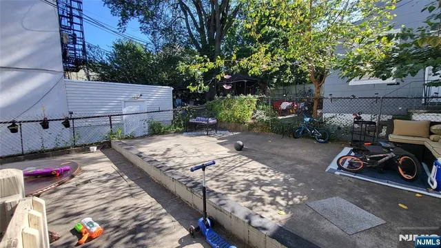 a view of a patio with table and chairs and potted plants