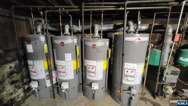 a utility room with dryer washer and stair