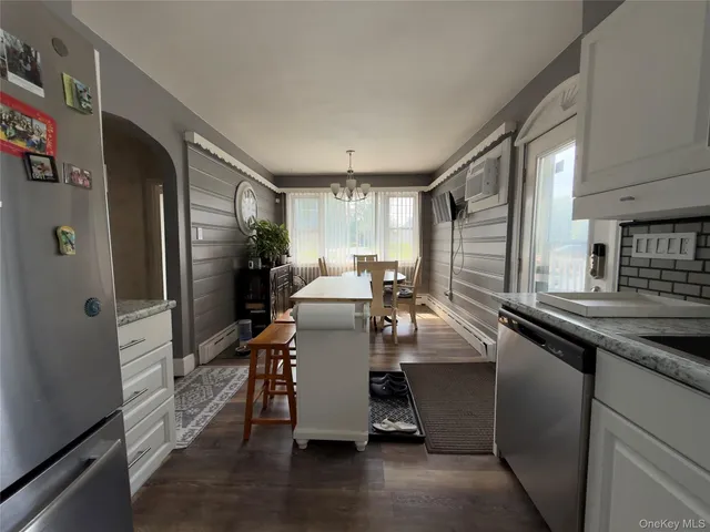 a kitchen with sink refrigerator and window
