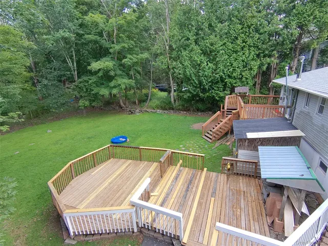 a view of a chairs and table on the roof deck