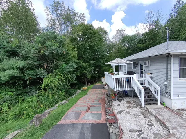 a front view of a house with garden and deck