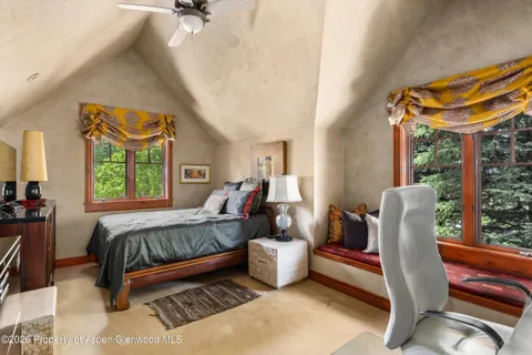 a bedroom with a bed and a chair