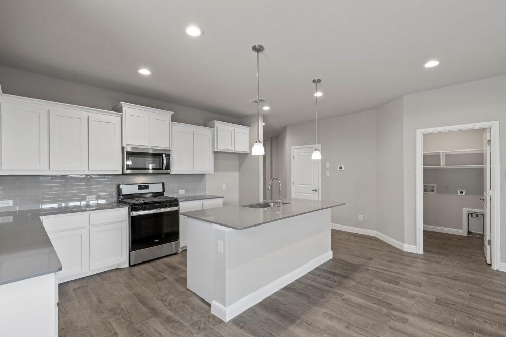 130 Lunayena Road Rhome, TX 76078 - Photo 2 of 39 a kitchen with stainless steel appliances kitchen island granite countertop a stove top oven a sink and a refrigerator