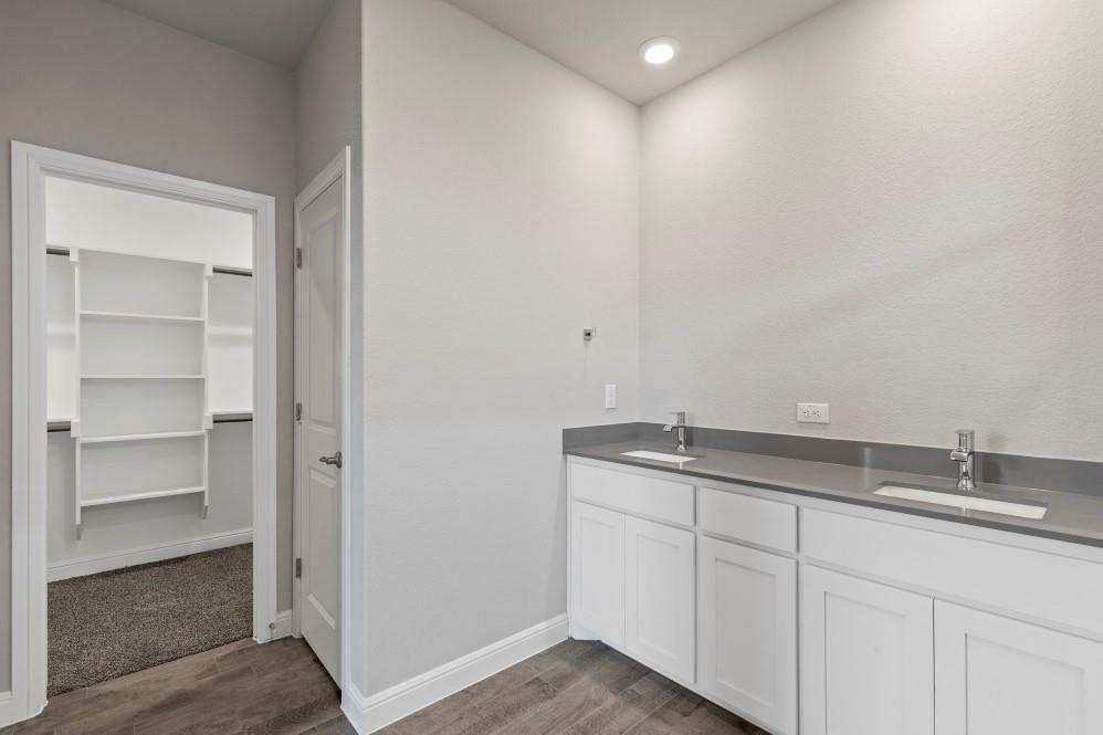 130 Lunayena Road Rhome, TX 76078 - Photo 22 of 39 a bathroom with a granite countertop sink and white cabinets