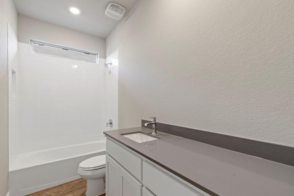130 Lunayena Road Rhome, TX 76078 - Photo 30 of 39 a bathroom with a granite countertop sink toilet and shower