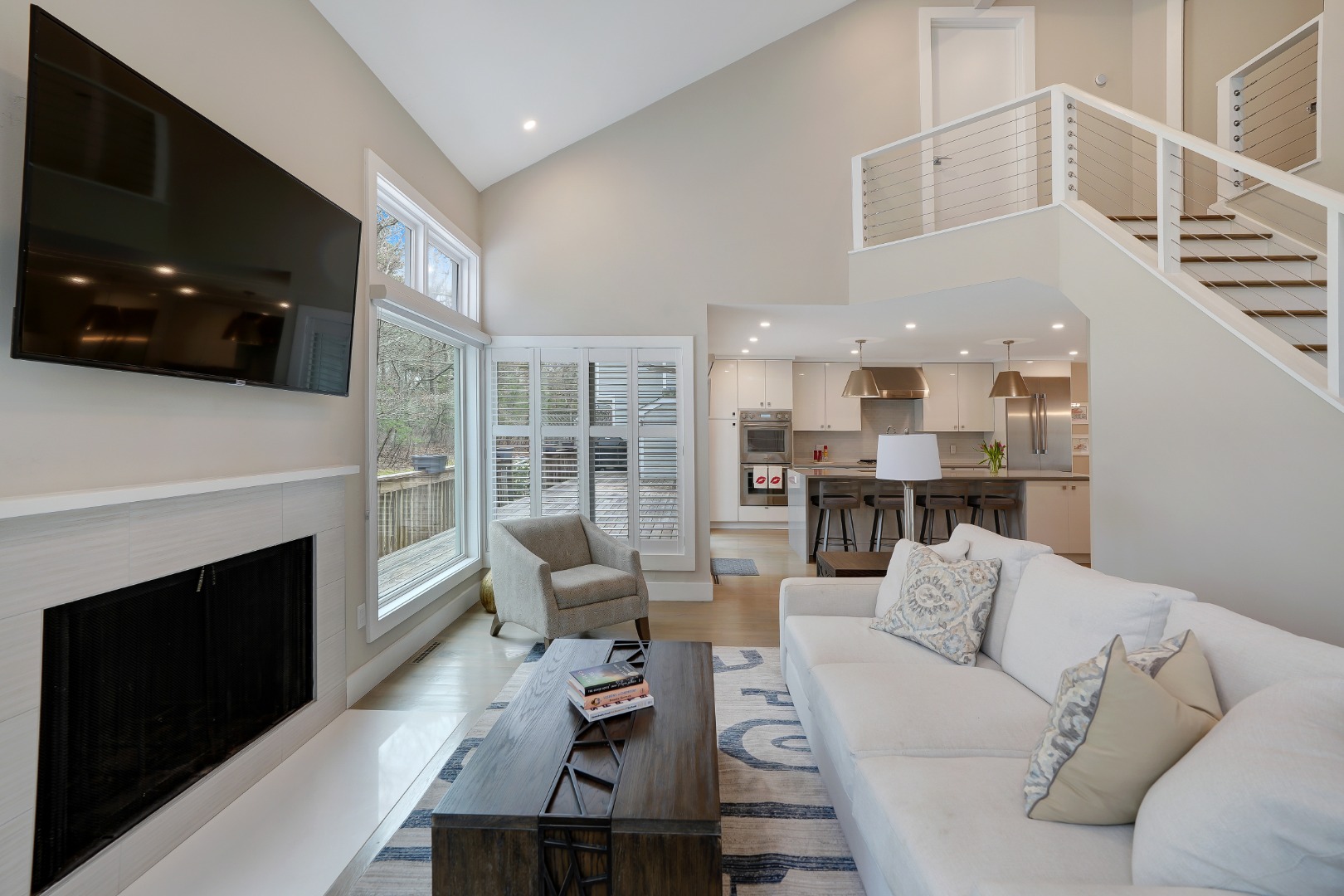 150 Cove Road, Unit 10 Vineyard Haven, MA 02568 - Photo 6 of 45 Light-filled living area with wood fireplace.