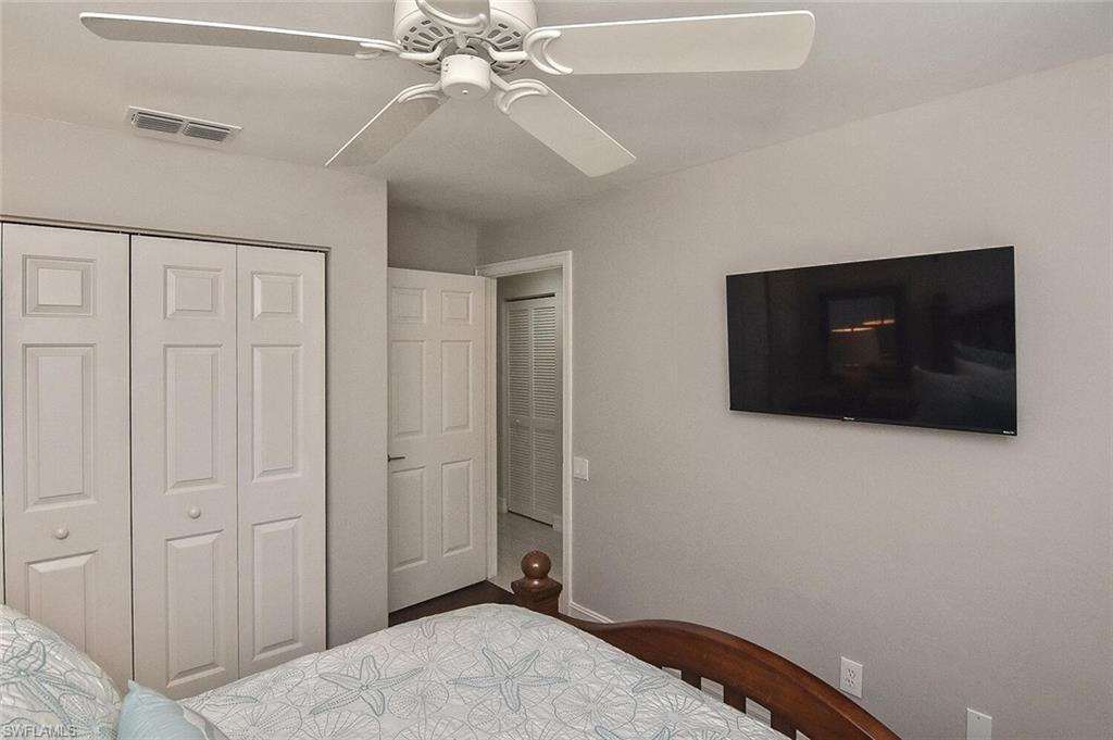 816 Carrick Bend Circle, Unit 202 Naples, FL 34110 - Photo 37 of 50 Bedroom featuring ceiling fan, a closet