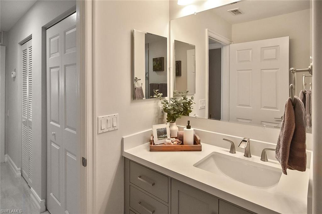 816 Carrick Bend Circle, Unit 202 Naples, FL 34110 - Photo 40 of 50 Guest Bathroom with vanity and a closet