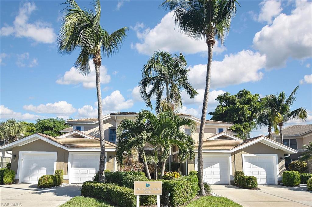 816 Carrick Bend Circle, Unit 202 Naples, FL 34110 - Photo 8 of 50 View of front of property with stucco siding, driveway, and a tiled roof