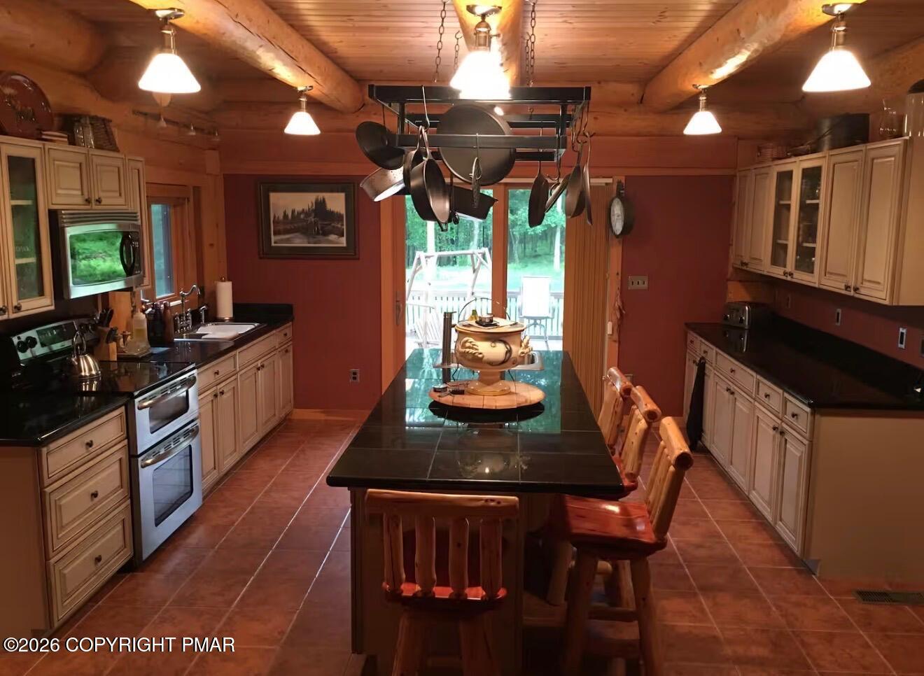 1673 Laurel Run Road Wilkes Barre, PA 18702 - Photo 8 of 19 a kitchen with stainless steel appliances kitchen island granite countertop a table chairs in it and wooden floors